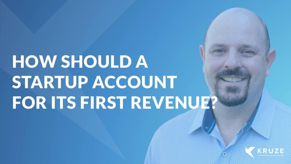 How should a startup account for its first revenue?