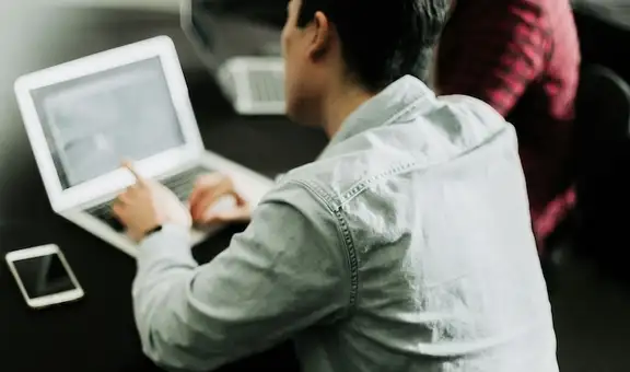 Image of a person working on a laptop